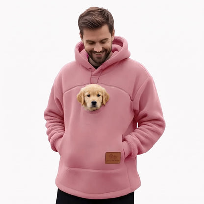 Homme en sweat à poche rose avec un chiot dans la poche